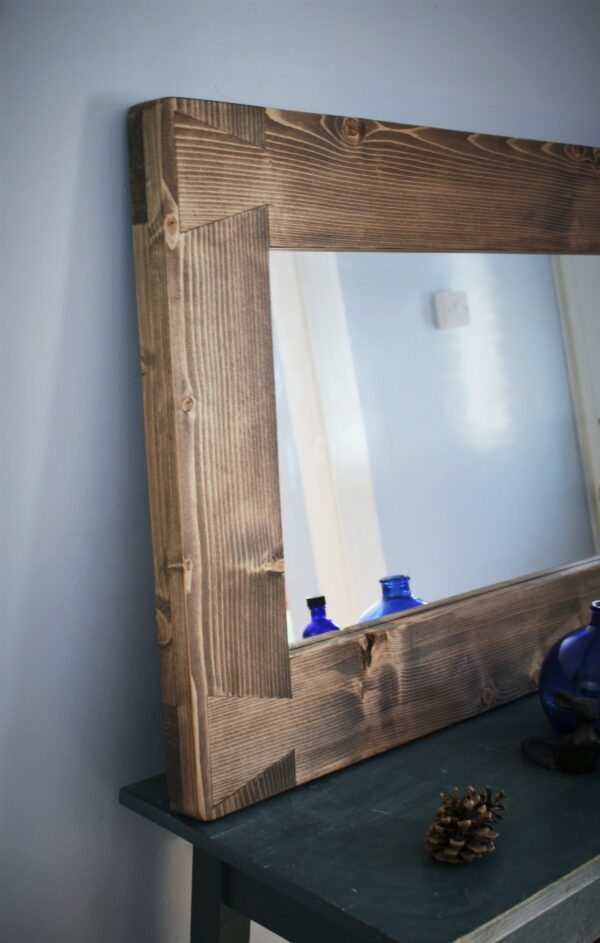 Rustic wooden mirror with chunky cottage farmhouse frame and dovetail joint decoration.
