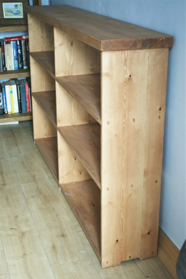 Wide wooden bookshelves in chunky rustic natural wood, handmade in Somerset UK. Top side view.