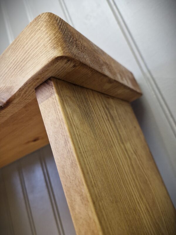 Slim wooden bookcase traditionally jointed with a chunky overhang top, custom handmade in Somerset UK