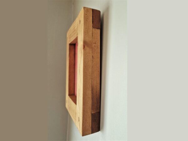 Small wooden picture frame, for 5 x 7 inch photo. Side view of chunky wooden frame, UK.