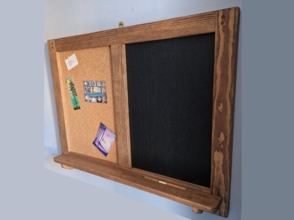 Wooden chalk cork board with rustic shelf; side view.