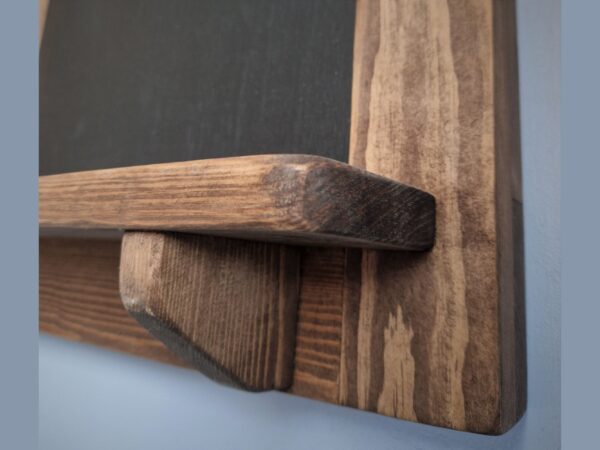 Wooden chalk cork board with rustic shelf detail.