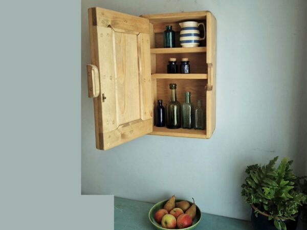 Kitchen wall cabinet, slim wooden storage cupboard for narrow space with door open.