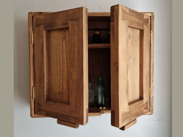 Farmhouse kitchen cabinet in natural wood, modern rustic style handmade in Somerset UK. With doors almost closed.