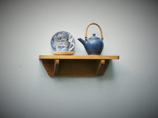 Small wooden kitchen shelf in chunky natural wood. For cookery books and plants, front view. Handmade in Somerset UK