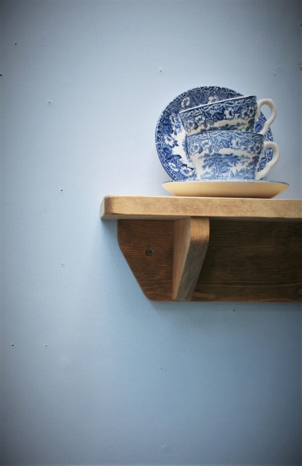 Small wooden kitchen shelf in chunky natural wood. For cookery books and plants, side view. Handmade in Somerset UK