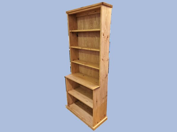 Tall step-back bookcase and large wooden bookshelf with a deep base is handmade in Somerset UK from natural rustic wood. Right side view.
