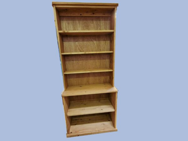 Tall step-back bookcase and large wooden bookshelf with a deep base is handmade in Somerset UK from natural rustic wood. Front view.