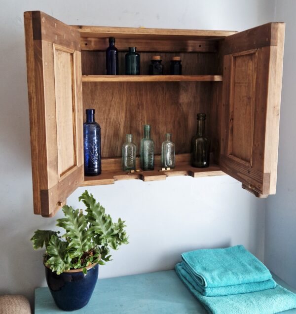Dark wood bathroom cupboard in natural wood, minimalist rustic style handmade in Somerset UK, doors open and full.