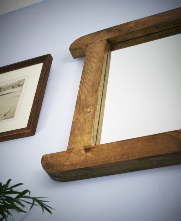 Arched mirror in dark wood, close up of side dovetail decoration. Handmade in Somerset UK