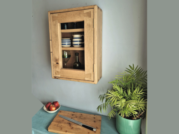 Glass door kitchen cabinet in rustic natural wood. Curio display glazed kitchen wall cabinet, handmade in Somerset UK.
