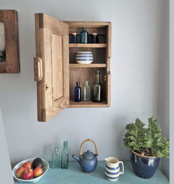 Slim dark kitchen cabinet in minimalist rustic style. With the door open. Handmade from natural wood in Somerset UK.