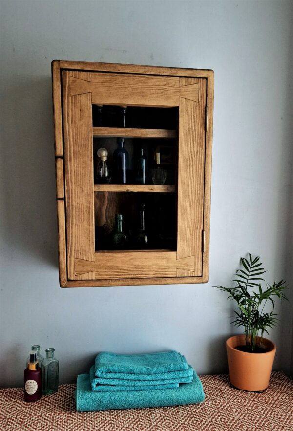 Glass door kitchen cabinet in dark wood. Minimalist rustic curio display cabinet is custom handmade in Somerset UK.