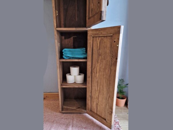 Slim tallboy bathroom cabinet and lower half of modern rustic dark wooden towel cupboard