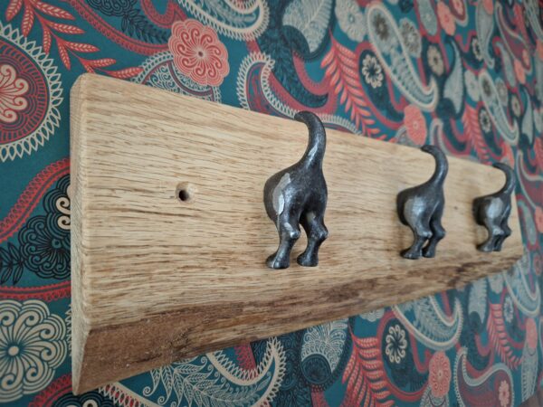 Live edge coat rack on Oak with dog tail cast iron hooks, side view, from Somerset UK