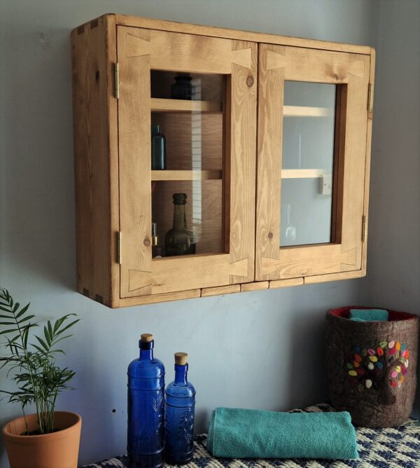 Bathroom cabinet with glass doors, side view of modern rustic cottage wooden cabinet from Somerset UK