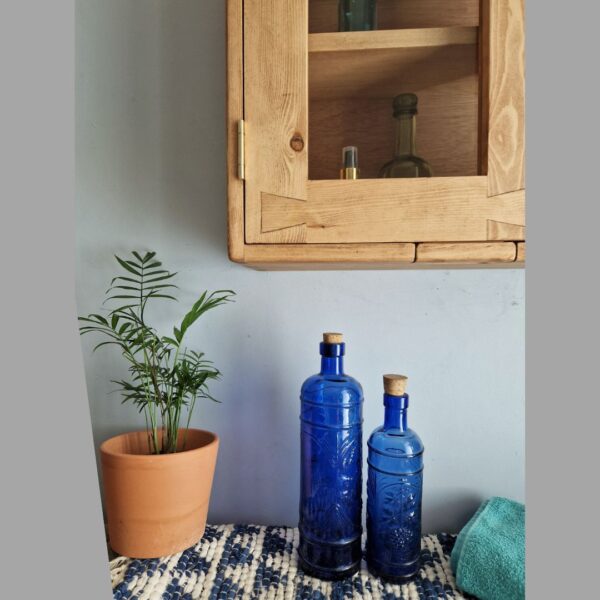 Bathroom cabinet with glass doors, close up of modern rustic wooden cabinet from Somerset UK